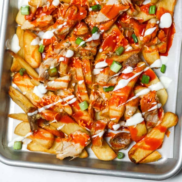 Philly Philly Cheesesteaks' loaded fries with chicken, buffalo sauce, ranch, and green onions.